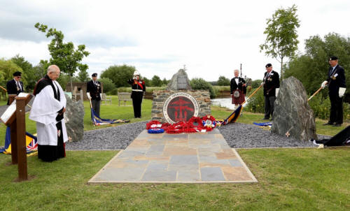 Buglar playing the last post at the memorial dedication ceremony.