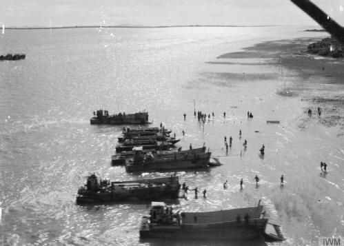 The Arakan Campaign January 1943 - May 1945: Landing craft on the beach at Akyab Island.